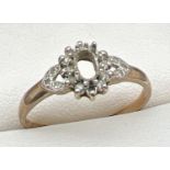 A 9ct gold vintage dress ring set with small round cut diamonds. Central stone missing and one small