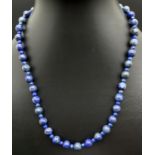 A 18" lapis lazuli beaded necklace with silver tone T bar clasp. Largest lapis beads approx. 7mm