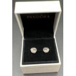 A boxed pair of silver Sparkling Love Knot stud style earrings by Pandora, set with small round