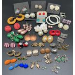 24 pairs of vintage costume jewellery earrings. To include stud, drop and hooped styles. Both