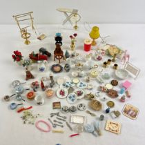 A collection of dolls house accessories. To include ironing board, plates, vases, crockery, lights