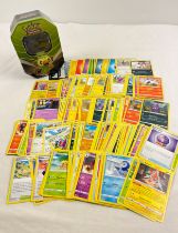 225 assorted Pokemon cards in an 2020 Pokemon from Galar Rillaboom V octagonal shaped tin. Cards