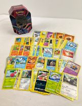 226 assorted Pokemon cards in a 2020 Pokemon V: Zacian octagonal shaped tin. Cards comprise 201