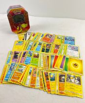 226 assorted Pokemon cards in a 2019 Pokemon - GX Flareon octagonal shaped tin. Cards comprise 200