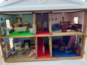 A handmade Regency style 2 storey dolls house with front opening doors and dolls house furniture. To