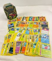 227 assorted Pokemon cards in a 2017 Alola Island Guardians Tapu Bulu GX octagonal shaped tin. Cards