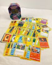 229 assorted Pokemon cards in a 2021 Pokemon V Galarian Slowbro octagonal shaped tin. Cards comprise