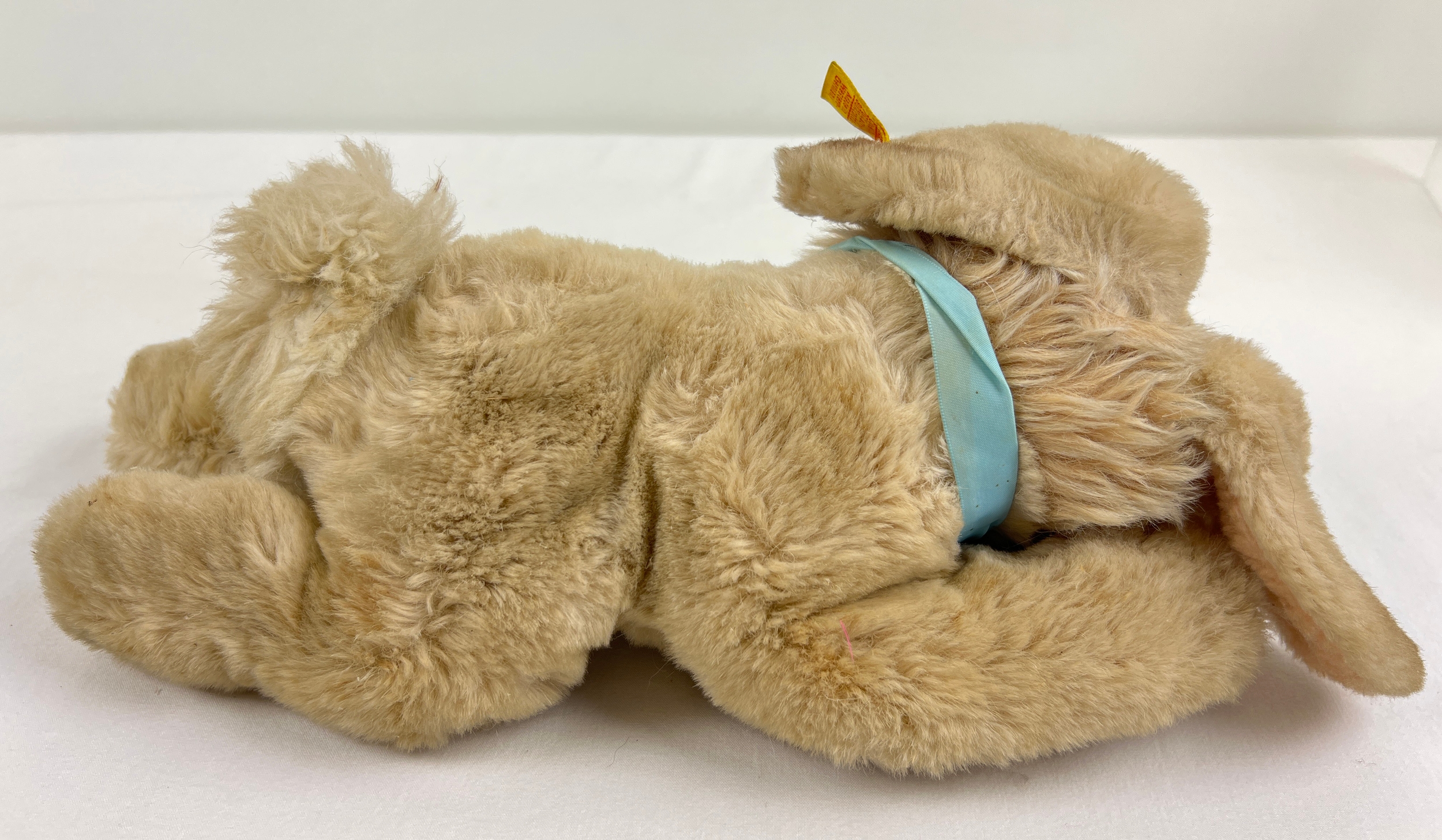A vintage Steiff reclining rabbit plush toy with blue ribbon necktie and buttoned ear. Approx. 12" - Image 3 of 3