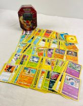 226 assorted Pokemon cards in a 2014 Kalos Region Delphox octagonal shaped tin. Cards comprise 201