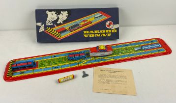 A vintage Russian tinplate 2 sectional train set with self loading/unloading cargo. Complete with