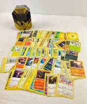 225 assorted Pokemon cards in a 2020 Pokemon V Powers Pikachu V octagonal shaped tin. Cards comprise