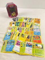 226 assorted Pokemon cards in a 2019 Pokemon - GX Jolteon octagonal shaped tin. Cards comprise 201