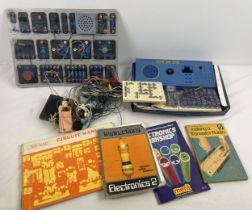 A collection of vintage children's electronic circuit boards, connectors, boxes and manuals. To