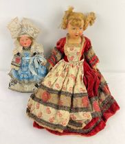 2 vintage French celluloid dolls, both in national dress. One with eagle mark to back of head.