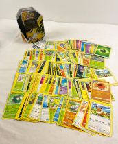 225 assorted Pokemon cards in a 2021 Pokemon V Jolteon octagonal shaped tin. Cards comprise 130