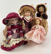 4 small bisque dolls with clothes and hats, largest approx. 8" long.