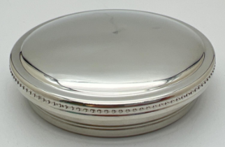 A round pewter lidded trinket box by Tiffany & Co. with beaded decoration to edge of lid. Blue
