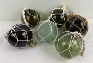 6 netted round glass floats/witches balls in amber, clear, blue and green glass. Each float