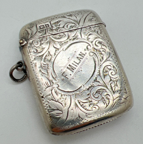 A large Edwardian silver vesta case with engraved scroll & foliate design and the name 'F. Milan'