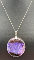 A large round natural stone pendant in purple and blue tones, possibly Blue John. On an 18 inch fine