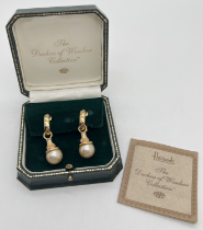 A boxed pair of The Duchess Of Windsor 22ct gold plated clip on faux pearl earrings. Decorated