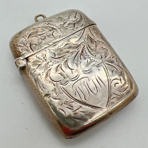 An ornately engraved Edwardian silver vesta case with scroll & foliate detail and engraved