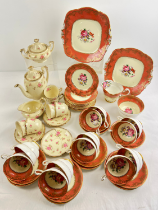 A quantity of vintage ceramic teaware. A 12 setting Paragon tea set with gilt and floral design