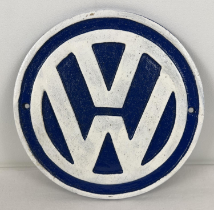 A circular shaped cast iron VW Volkswagen wall plaque painted blue & white. Approx. 23cm diameter.