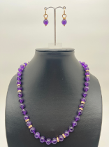 An 18 inch amethyst and 9ct gold bead necklace with matching drop earrings. Round amethyst beads