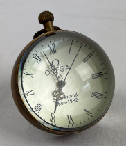 A top winding glass ball watch, bound in brass with roman numeral markers. Approx. 6cm diameter.