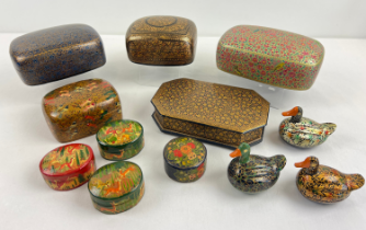 A collection of assorted ethnic wooden lacquer lidded trinket boxes with painted detail. Some with