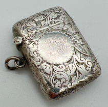 A small Victorian silver vesta case with decorative scroll & foliate engraved detail throughout.