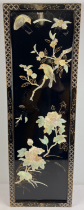 An Oriental black lacquer wall panel depicting birds & flowers carved from shell, applied in relief.