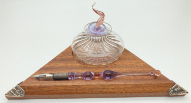 A modern wood and glass ink stand with 800 silver corner mounts. Clear glass ink bottle with