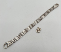 A heavy white metal gate link bracelet with large lobster style clasp and extra link. Indistinct