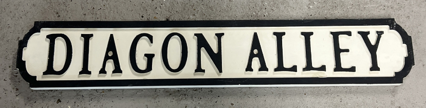 A modern painted wood Harry Potter 'Diagon Alley' sign, in the style of an old street sign.