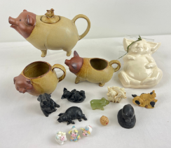 A collection of assorted pig ornaments and collectables to include studio pottery teapot, milk jug