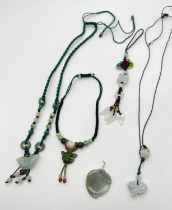4 items of corded jade jewellery together with a jade and coloured cord bag charm. A necklace with