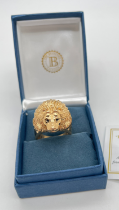 A boxed Bradford Exchange 24K gold plated stainless steel "Heart Of A Lion" men' dress ring. Lions