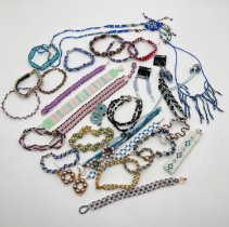 A collection of 30 assorted handmade seed bead jewellery items to include necklaces, bracelets and