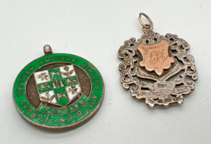 2 vintage silver medallions. A pierced work shield with rose gold detail to one side with engraved