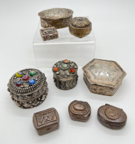 A collection of assorted white metal pill boxes and trinket boxes, to include glass bead and stone