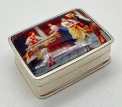 A small silver rectangular shaped pill box with hinged lid set with ceramic plaque. Stamped sterling