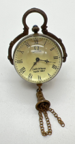 A brass bound ball watch pendant with tassel detail, roman numeral markers & hinged pendant bale.