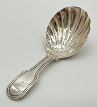 A George III silver tea caddy spoon with bowl modelled as a scallop shell and channelled detail to