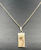 A modern design white metal rectangular pendant with 9ct gold leaf detail to front, on an 18" silver