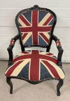 A Louis XV style reproduction armchair painted black with Union Jack design upholstered seat back