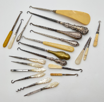 A collection of assorted antique button hooks and vanity tools, to include silver and pearl