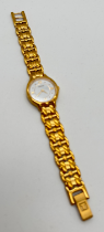 A ladies gold tone stainless steel strap wristwatch by Tissot. White face with gold tone hour