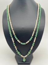 A double row pearl and green jade bead necklace with jade drop, gold tone metal spacer beads and